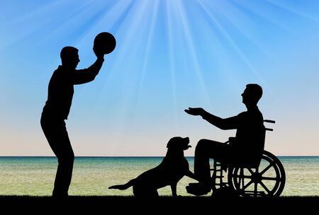 Silhouette of a disabled man in a wheelchair playing ball with a friend by the sea coast and a dog. The concept of fun pastime for people with disabilitiesの写真素材