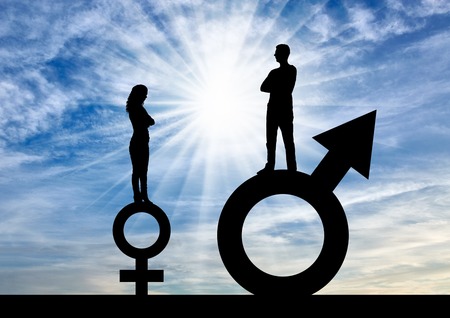 Silhouette of a big man and a small woman standing on gender symbols. The concept of gender inequalityの写真素材