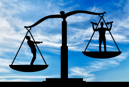 Silhouette of an ordinary man on scales of justice, he is in priority and he laughs at a selfish man with a crown on his head.の写真素材