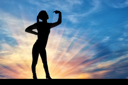 Silhouette of a narcissistic woman showing her finger at yourself. Paying attention to yourself. The concept of narcissism and selfishnessの写真素材