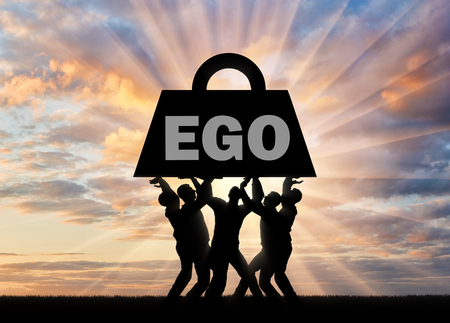 The silhouette of a selfish crowd keeps a heavy load - the ego. The conceptual scene of selfishness as a problem of societyの写真素材
