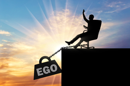Silhouette of a selfish boss sitting in a chair and a heavy load of ego, pulling him into the abyss. Conceptual scene of selfishnessの写真素材