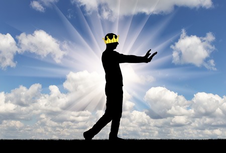 A selfish man walks, he is blind, his crown closes his eyes to see. Conceptual scene is a narcissistic and selfish personの写真素材