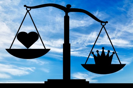 Symbol crown selfishness in priority over the symbol of the heart altruism on the scales. The concept of the predominance of egoism in societyの写真素材
