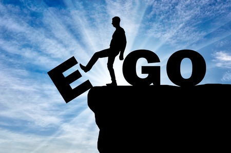 Conceptual image of the fight against egoism. Silhouette of a man gets rid of the ego as a bad habit.の写真素材