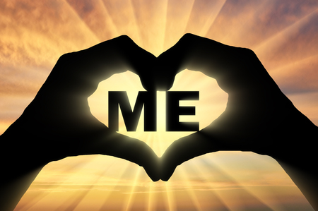 Man's hands hold the word to me, showing that he likes this as a symbol of the heart. Concept of selfishnessの写真素材