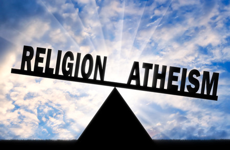 Word atheism is more powerful than the word religion on the scales. Concept of atheismの写真素材