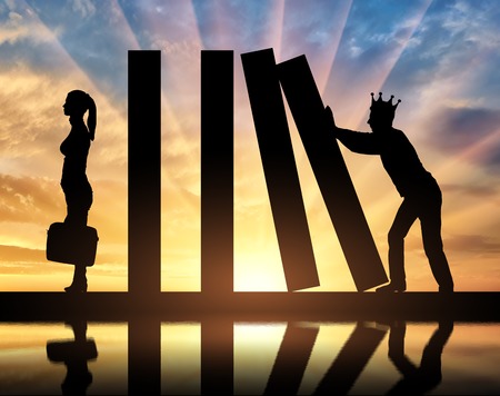 Selfish man with a crown on his head makes a domino effect in relation to the woman. The concept of selfishness in societyの写真素材