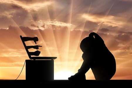 Silhouette sad girl child crying sitting in front of a laptop he shows the hands of people with negative gestures and threats. Conceptual image of cyber bullying childrenの写真素材