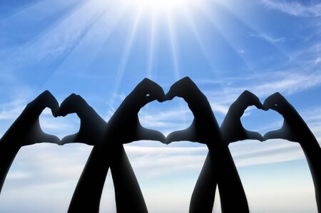 Altruism concept. Three pairs of hands show a heart symbolの写真素材