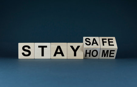Stay home - stay safe. Concept of lockdown and curfew. Cubes form the expression stay home - stay safe.の写真素材