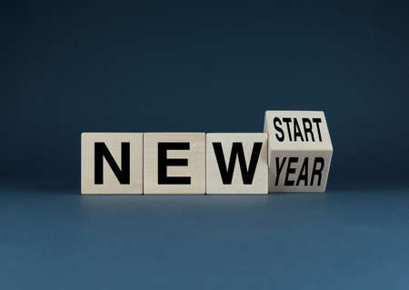 New year - new start. Cubes form words New year - new start. The concept of new goals, habits and motivations in life or business.の写真素材