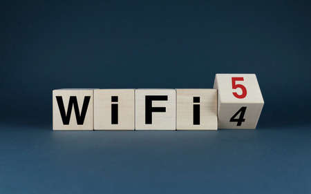 WiFi 4 to WiFi 5. Cubes form the words WiFi 4 to WiFi 5. The concept of moving to the latest wireless network standards. Internet technologies - Communicationsの写真素材