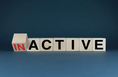 Inactive or Active. Cubes form words Inactive or Active. The concept of activity both in business and in lifeの写真素材