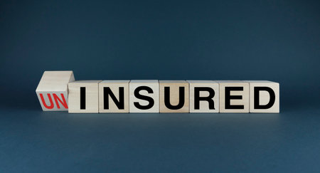 Uninsured or Insured. Cubes form the choice words Uninsured or Insured. Concept of any kind of insuranceの写真素材