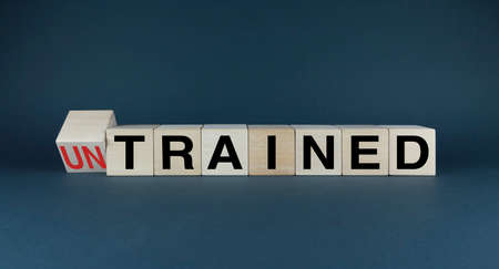 Untrained or Trained. Cubes form the choice words Untrained or Trained. Concept of Untrained or Trained both in business and in other areas of lifeの写真素材