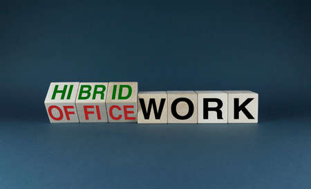 Office work or Hybrid work. Cubes form the choice words Office work or Hybrid work. The concept of online remote work, not standard office workの写真素材