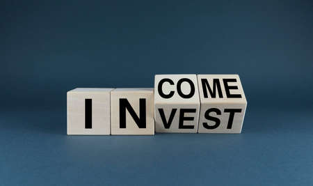 Invest - Income. Cubes form words Invest - Income. business conceptの写真素材