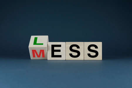 Less mess. Cubes form words Less Mess. The concept of organization, optimization and order from business to everyday lifeの写真素材