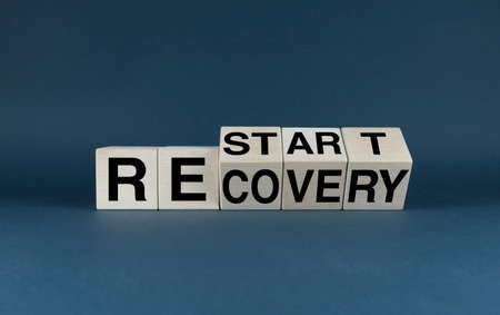 Restart or recovery. The cubes form the words Restart or Recovery. business, work and economy conceptの写真素材