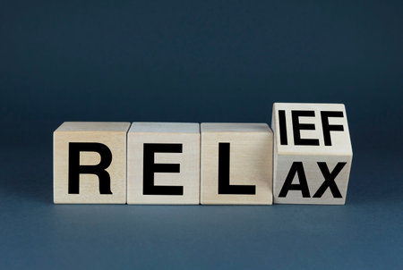 Relax - Relief. Cubes form words Relax - Relief. Concept of rest and relaxation from business, work and bustleの写真素材