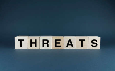 Threats. Cubes form the word Threats. An extensive concept of the word Threats used in different areas of lifeの写真素材