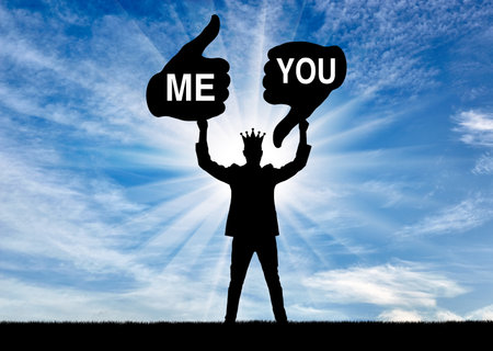 selfishness. A selfish and arrogant man with a crown holding a like sign addressed to him and a dislike addressed to other people. The concept of egoism, arrogance. social problems. Silhouetteの写真素材