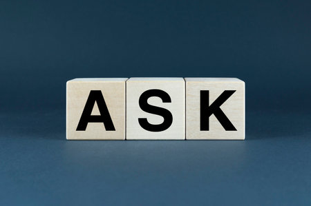 A minimalistic composition featuring three wooden blocks spelling out the word 'ASK'. This image symbolizes the power of inquiry, curiosity, and the beginning of a conversation. Perfect for concepts related to education, problem-solving, and customer serviceの写真素材