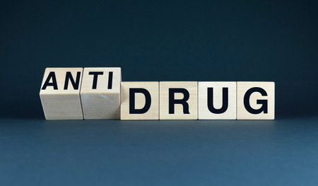 A conceptual image featuring the words ANTI DRUG spelled out on wooden blocks, symbolizing the global fight against substance abuseの写真素材