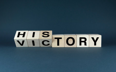 Words Historic Victory spelled out in wooden blocks. This image conveys a sense of triumph and achievement, suggesting a significant event that has changed the course of history. It is perfect for use in historical documents, educational materials, and any project that aims to commemorate a past victoryの写真素材