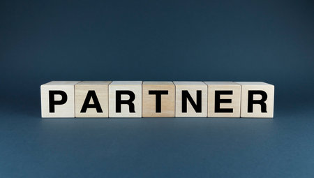 A conceptual image of wooden blocks spelling out the word PARTNER. This image symbolizes the importance of partnerships in business, collaboration, and mutual growth. Perfect for presentations, reports, and marketing materials related to business partnershipsの写真素材