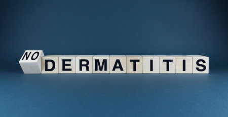 Words DERMATITIS or NO DERMATITIS spelled out on wooden blocks, symbolizing clear and healthy skin free from dermatitis. Perfect for skincare, dermatology, and health and wellness themesの写真素材