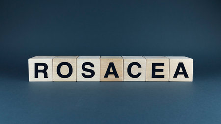 A conceptual image representing the skin condition rosacea. Wooden blocks spelling ROSACEA create a simple yet impactful visual. Ideal for illustrating articles, brochures, or any project related to dermatology and skin careの写真素材