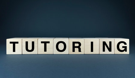 Wooden blocks spelling out the word TUTORING against a clean, white background. Perfect for presentations, websites, or any project related to education, learning, and academic supportの写真素材
