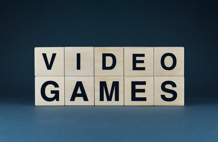 Wooden blocks spelling VIDEO GAMES symbolize the vast and diverse realm of video games. Ideal for...