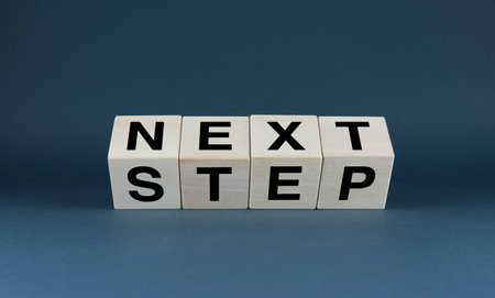 Wooden blocks spelling NEXT STEP. This concept is perfect for personal development, goal setting, and planning-related projectsの写真素材