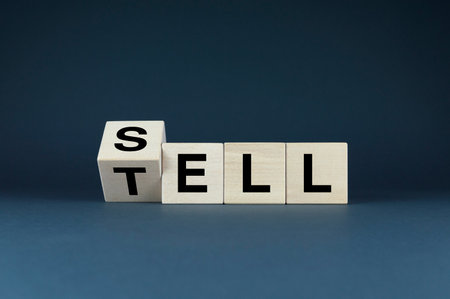 A conceptual image symbolizing the power of language in sales. The wooden blocks with the words Sell and Tell represent the idea that the right words can persuade customers to buyの写真素材