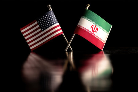 Miniature American and Iranian flags cross, their reflections mirroring a complex geopolitical landscape. International relations, diplomacy, and global politics are suggested.の素材