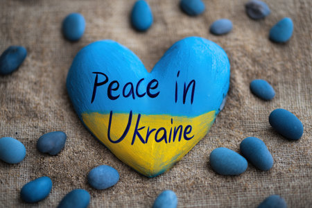 Ukraine war support illustration. Heart with peace inscription in Ukraine flag colors. Symbolizes solidarity, empathy, pray, hope, love and international support.の素材