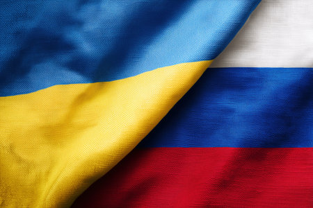 Close up of Ukrainian and Russian flags depicting geopolitical tensions and symbolizing international relations, national identity, and patriotism with vivid hues.の素材