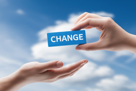 One hand gives another a blue block with the word CHANGE. This is a concept for business transformation, corporate change, and new opportunities.の素材