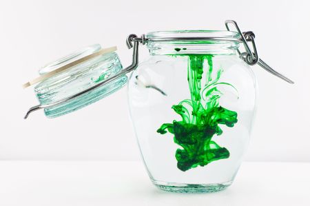 An antique jar full of water with green colour.の写真素材