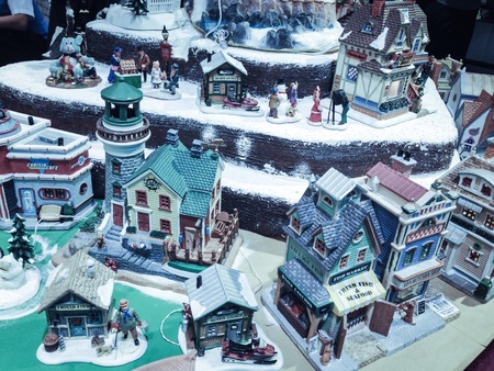 Miniature village showing winter season. Snows wherever the streets a man giving gift to a child.. Favorite season of the yearの素材