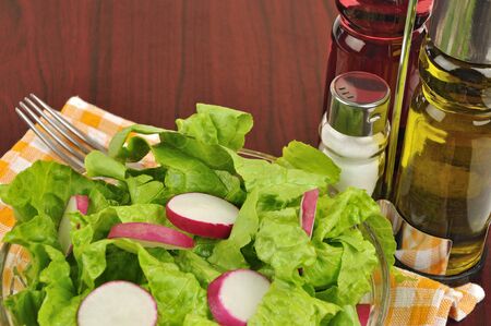 Mixed salad with lettuce and radish on wooden background close upの写真素材