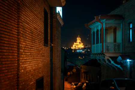 Georgia, Tbilisi - 05.02.2019. - Night scene from the streets of Tbilisi old town. Beautiful holy trinity Sameba church in the background - Night imageのeditorial素材