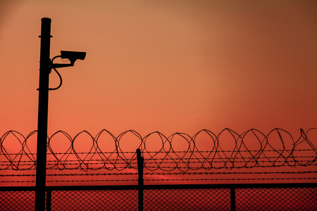 Silhouette Security CCTV camera with beautiful sunsetの写真素材