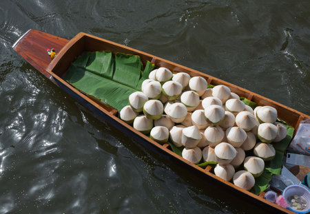 The boat sells coconut at the water market.の写真素材