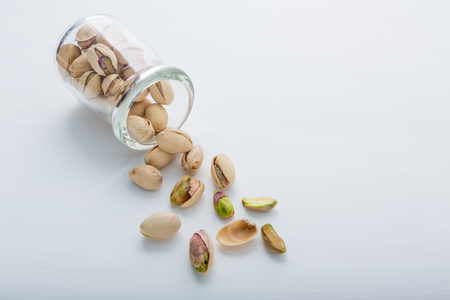 Pistachios in bottle on white background.の写真素材