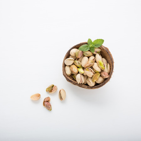 Pistachios in bowl on white background.の写真素材