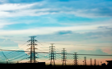 high voltage electric towers during sunsetの写真素材